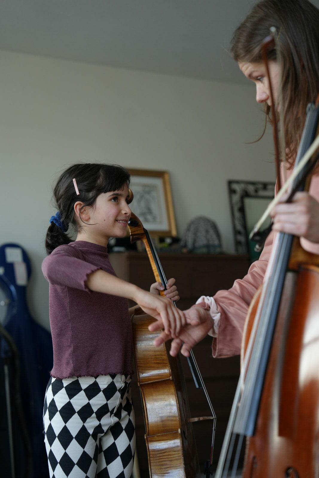 Young cellist in a lesson