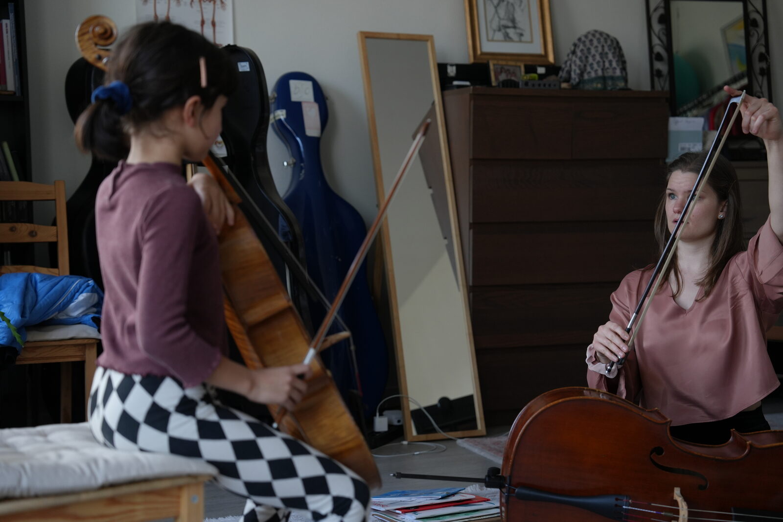 Student and teacher playing cello